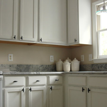 Oak kitchen cabinets painted bright white with light distress