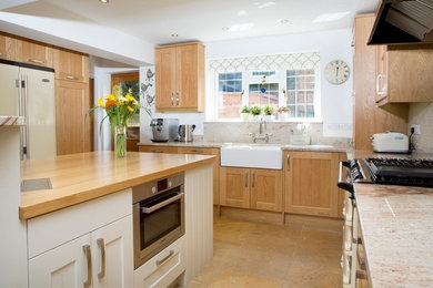 This is an example of a medium sized traditional kitchen in Oxfordshire with shaker cabinets, granite worktops and an island.