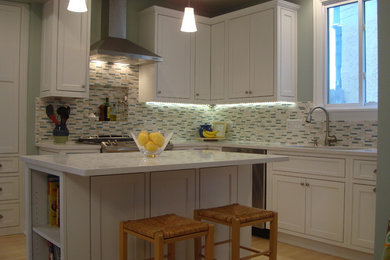 Inspiration for a mid-sized timeless l-shaped eat-in kitchen remodel in Chicago with beaded inset cabinets, white cabinets, granite countertops and an island