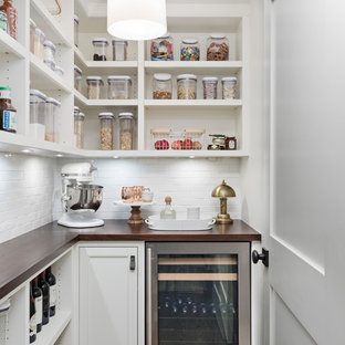 This is an example of a transitional l-shaped kitchen pantry in Detroit with open cabinets, white cabinets, wood benchtops, white splashback, stainless steel appliances, dark hardwood floors, brown floor and brown benchtop.