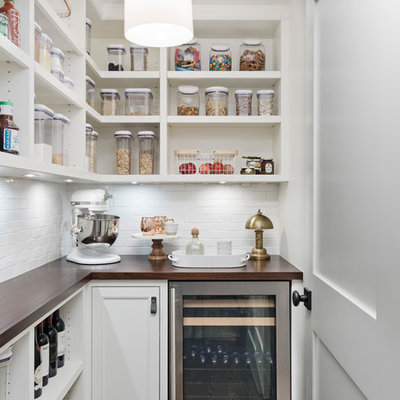 Transitional l-shaped dark wood floor and brown floor kitchen pantry photo in Detroit with open cabinets, white cabinets, wood countertops, white backsplash, stainless steel appliances and brown countertops