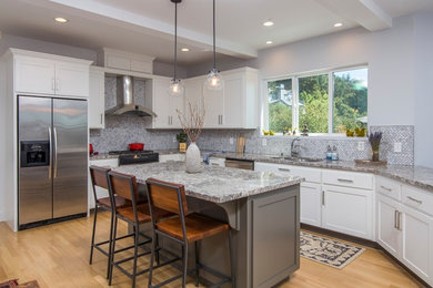 Kitchen - transitional light wood floor kitchen idea in San Francisco with a double-bowl sink, shaker cabinets, white cabinets, gray backsplash, stainless steel appliances, an island and gray countertops