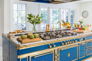Eat-in kitchen - large traditional eat-in kitchen idea in New York with an integrated sink, stainless steel countertops, an island, stainless steel cabinets, blue backsplash and blue countertops