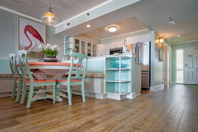 Kitchen - mid-sized coastal vinyl floor and white floor kitchen idea in Other with a farmhouse sink, shaker cabinets, stainless steel appliances and an island