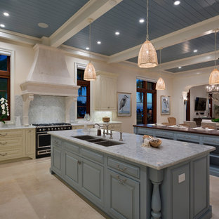 Mediterranean open concept kitchen ideas - Open concept kitchen - mediterranean l-shaped white floor open concept kitchen idea in Other with an undermount sink, raised-panel cabinets, blue cabinets, gray backsplash, black appliances, two islands and gray countertops