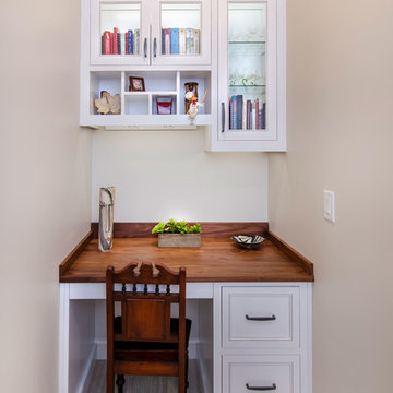 Office desk with custom wood top cabinets are painted designer white