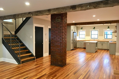 Kitchen - mid-sized farmhouse u-shaped medium tone wood floor and brown floor kitchen idea in Cleveland with a farmhouse sink, shaker cabinets, gray cabinets, wood countertops, white backsplash, subway tile backsplash, stainless steel appliances, an island and brown countertops