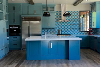 Inspiration for a mid-sized contemporary u-shaped light wood floor eat-in kitchen remodel in Los Angeles with shaker cabinets, blue cabinets, quartz countertops, blue backsplash, cement tile backsplash, stainless steel appliances and an island