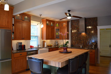 Kitchen - transitional kitchen idea in Huntington with a farmhouse sink, flat-panel cabinets and an island