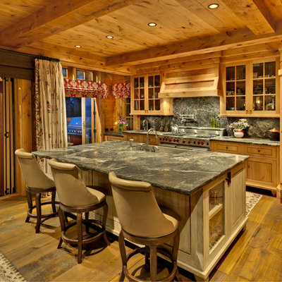 Inspiration for a rustic galley dark wood floor kitchen remodel in Sacramento with a farmhouse sink, shaker cabinets, medium tone wood cabinets, gray backsplash and an island