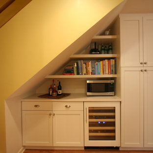 Small contemporary open concept kitchen photos - Inspiration for a small contemporary galley medium tone wood floor open concept kitchen remodel in Chicago with an undermount sink, shaker cabinets, white cabinets, quartz countertops, beige backsplash, stone tile backsplash, stainless steel appliances and no island