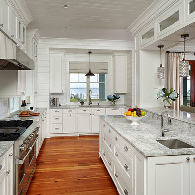 Kitchen - tropical kitchen idea in Charleston with recessed-panel cabinets, white cabinets, white backsplash, subway tile backsplash and stainless steel appliances