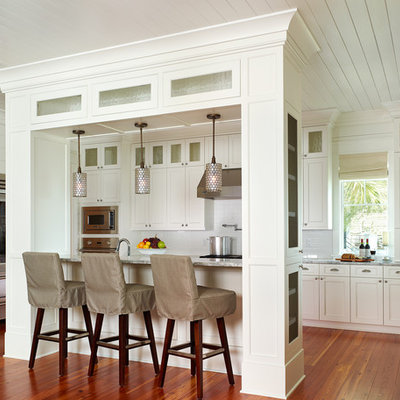 Kitchen - tropical kitchen idea in Charleston with shaker cabinets, stainless steel appliances, white cabinets and white backsplash