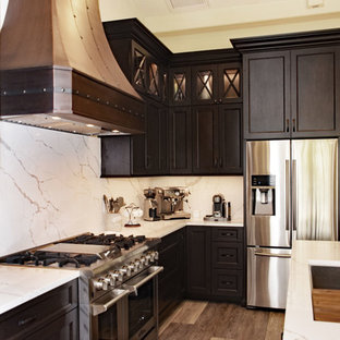 This is an example of a large mediterranean l-shaped eat-in kitchen in Other with an undermount sink, shaker cabinets, dark wood cabinets, quartz benchtops, white splashback, stone slab splashback, stainless steel appliances, vinyl floors, multiple islands, grey floor and white benchtop.