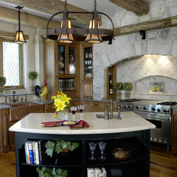 Old World Kitchen with Stone Wall and Reclaimed Ceiling Beams