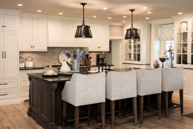 Example of a country galley light wood floor eat-in kitchen design in Philadelphia with recessed-panel cabinets, white cabinets, wood countertops and an island