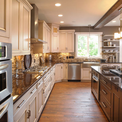 Elegant kitchen photo in Columbus with stainless steel appliances, a farmhouse sink, recessed-panel cabinets, beige cabinets, brown backsplash and matchstick tile backsplash