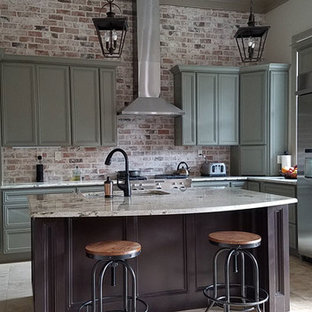 Inspiration for a mid-sized industrial l-shaped eat-in kitchen in Houston with an undermount sink, recessed-panel cabinets, green cabinets, granite benchtops, red splashback, brick splashback, stainless steel appliances, ceramic floors, with island and beige floor.