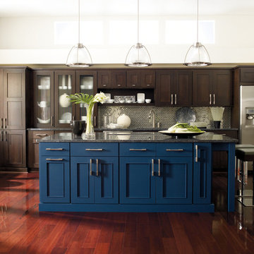 Omega Cabinetry: Dark Wood Cabinets with Bold Blue Island