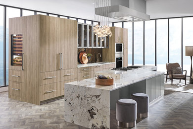 Inspiration for a large contemporary eat-in kitchen remodel in Other with an integrated sink, flat-panel cabinets, light wood cabinets, metallic backsplash, stainless steel appliances and an island