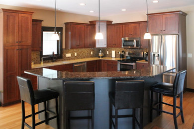 Inspiration for a large timeless l-shaped bamboo floor and brown floor open concept kitchen remodel in Cedar Rapids with an undermount sink, shaker cabinets, medium tone wood cabinets, quartzite countertops, brown backsplash, ceramic backsplash, stainless steel appliances and an island