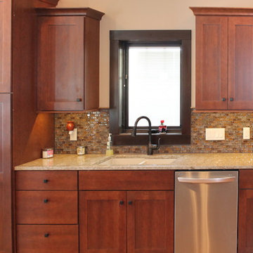 Omega Cabinetry, Monterey door, Cherry wood, Canyon/Smokey Hills stain.
