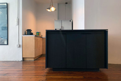 Trendy kitchen photo in New York with black cabinets and black countertops