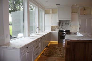 Large elegant l-shaped medium tone wood floor eat-in kitchen photo in Jacksonville with an undermount sink, marble countertops, white backsplash, stone slab backsplash and stainless steel appliances