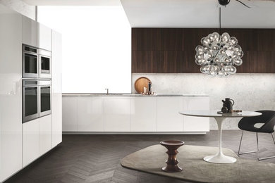 Inspiration for a medium sized modern l-shaped open plan kitchen in Toronto with a submerged sink, flat-panel cabinets, white cabinets, marble worktops, stainless steel appliances, dark hardwood flooring and no island.