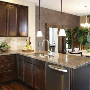 Inspiration for a small modern u-shaped open plan kitchen in San Francisco with an integrated sink, shaker cabinets, dark wood cabinets, granite benchtops, metallic splashback, metal splashback, stainless steel appliances, ceramic floors and with island.
