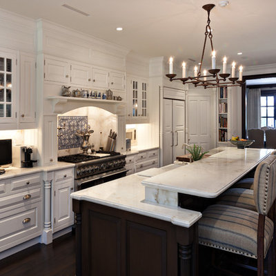 Example of a tuscan galley kitchen design in Miami with raised-panel cabinets, blue backsplash and paneled appliances
