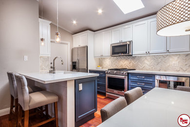Small trendy galley medium tone wood floor eat-in kitchen photo in Orange County with an undermount sink, raised-panel cabinets, white cabinets, quartz countertops, white backsplash, stainless steel appliances and no island