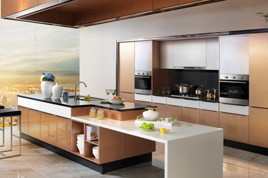 Example of a mid-sized trendy galley open concept kitchen design in Los Angeles with an undermount sink, flat-panel cabinets, stainless steel appliances and an island