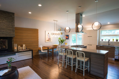 Open concept kitchen - mid-sized contemporary l-shaped dark wood floor open concept kitchen idea in New York with a double-bowl sink, flat-panel cabinets, dark wood cabinets, solid surface countertops, white backsplash, subway tile backsplash, stainless steel appliances and an island