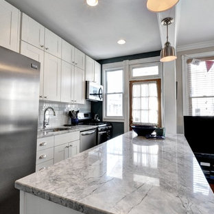Design ideas for a mid-sized transitional galley eat-in kitchen in DC Metro with an undermount sink, shaker cabinets, white cabinets, quartzite benchtops, white splashback, subway tile splashback, stainless steel appliances, porcelain floors and with island.
