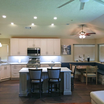 Open concept transitional kitchen has white & gray cabinets and Cambria Montgome