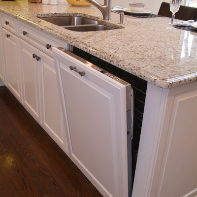 Eat-in kitchen - mid-sized contemporary u-shaped dark wood floor eat-in kitchen idea in Boston with a double-bowl sink, beaded inset cabinets, white cabinets, granite countertops, beige backsplash, mosaic tile backsplash, stainless steel appliances and a peninsula