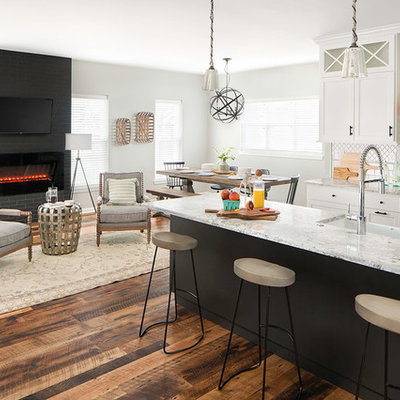 Huge transitional galley medium tone wood floor and brown floor eat-in kitchen photo in Columbus with a farmhouse sink, shaker cabinets, white cabinets, quartz countertops, white backsplash, ceramic backsplash, stainless steel appliances and an island