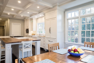 Example of a mid-sized transitional dark wood floor and brown floor eat-in kitchen design in Philadelphia with a farmhouse sink, shaker cabinets, white cabinets, marble countertops, ceramic backsplash, stainless steel appliances, two islands and white countertops