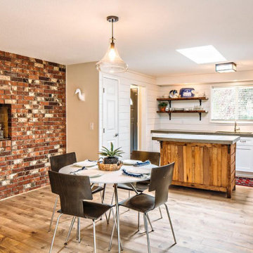 Open kitchen, dining, wet bar with ample light.