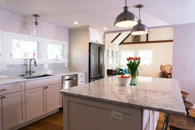 Inspiration for a mid-sized timeless l-shaped dark wood floor and brown floor eat-in kitchen remodel in Boston with a double-bowl sink, flat-panel cabinets, white cabinets, quartzite countertops, blue backsplash, subway tile backsplash, stainless steel appliances, an island and gray countertops