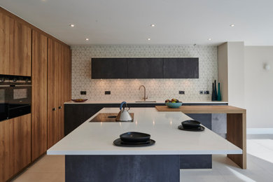 Design ideas for a large contemporary l-shaped open plan kitchen in Other with flat-panel cabinets, grey cabinets, quartz worktops, an island and white worktops.