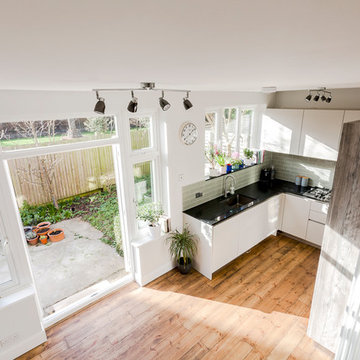 Open plan kitchen living space defined by bespoke joinery
