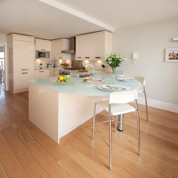 Open plan kitchen with large glass topped breakfast table