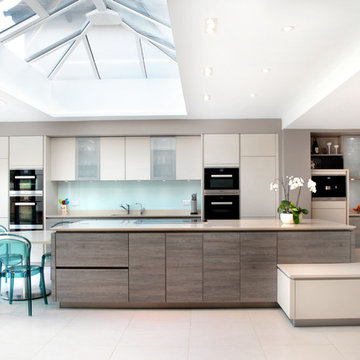 Open plan, matt cashmere & grey wood effect kitchen with skylight