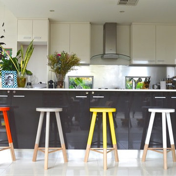 Orange, Taupe, Yellow and White Stools set against the dark kitchen cupboards