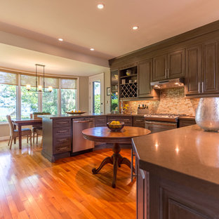 Large contemporary l-shaped eat-in kitchen in Toronto with raised-panel cabinets, green cabinets, multi-coloured splashback, mosaic tile splashback, bamboo floors and brown floor.