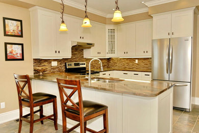 Inspiration for a contemporary u-shaped ceramic tile eat-in kitchen remodel in Other with an undermount sink, flat-panel cabinets, white cabinets, granite countertops, multicolored backsplash, glass tile backsplash, stainless steel appliances and an island