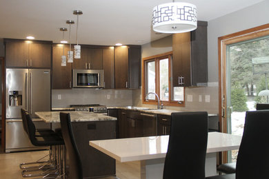 Eat-in kitchen - mid-sized contemporary l-shaped ceramic tile and gray floor eat-in kitchen idea in New York with an undermount sink, flat-panel cabinets, brown cabinets, quartzite countertops, gray backsplash, glass tile backsplash, stainless steel appliances, an island and gray countertops