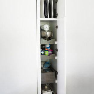 Mid-sized transitional eat-in kitchen designs - Eat-in kitchen - mid-sized transitional l-shaped porcelain tile and gray floor eat-in kitchen idea in New York with a single-bowl sink, flat-panel cabinets, white cabinets, quartzite countertops, brown backsplash, brick backsplash, stainless steel appliances and an island